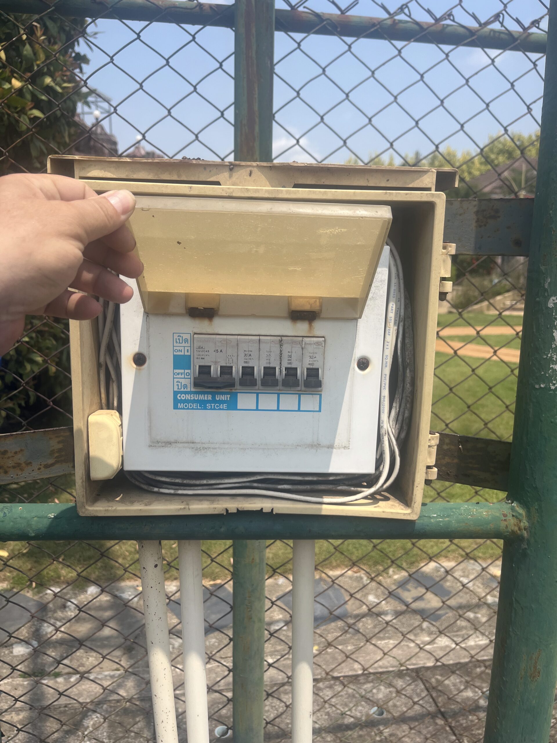 Deteriorated makeshift outdoor electrical breaker box exposed to weather before upgrade by ACES Pattaya