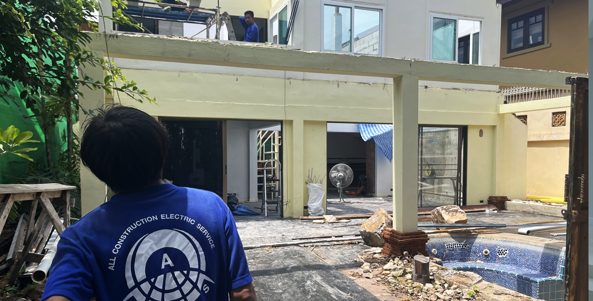 ACES Pattaya construction technician overseeing structural outdoor building extension and patio construction work
