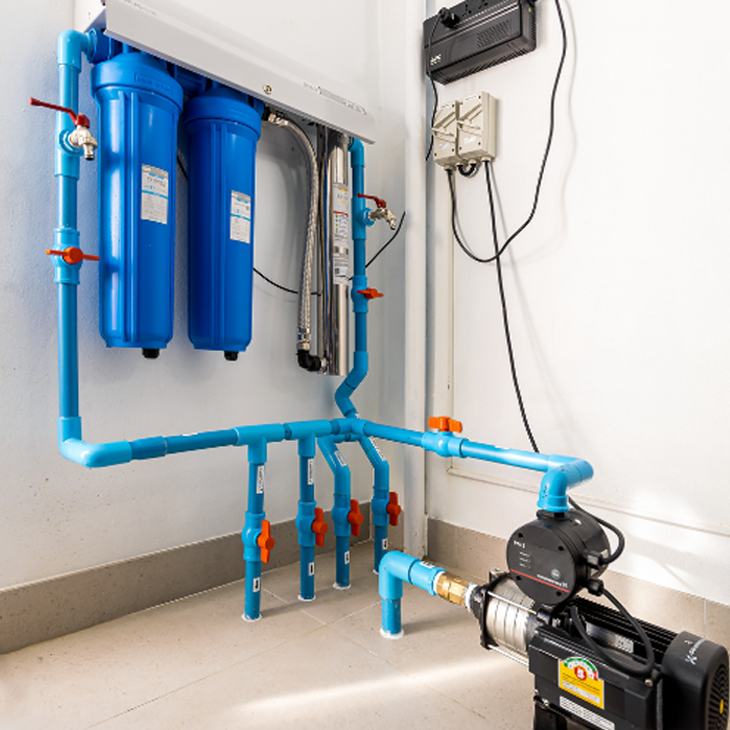 ACES Pattaya whole-house water filtration system with dual blue cartridge filters, high-pressure plumbing manifold, and electric booster pump