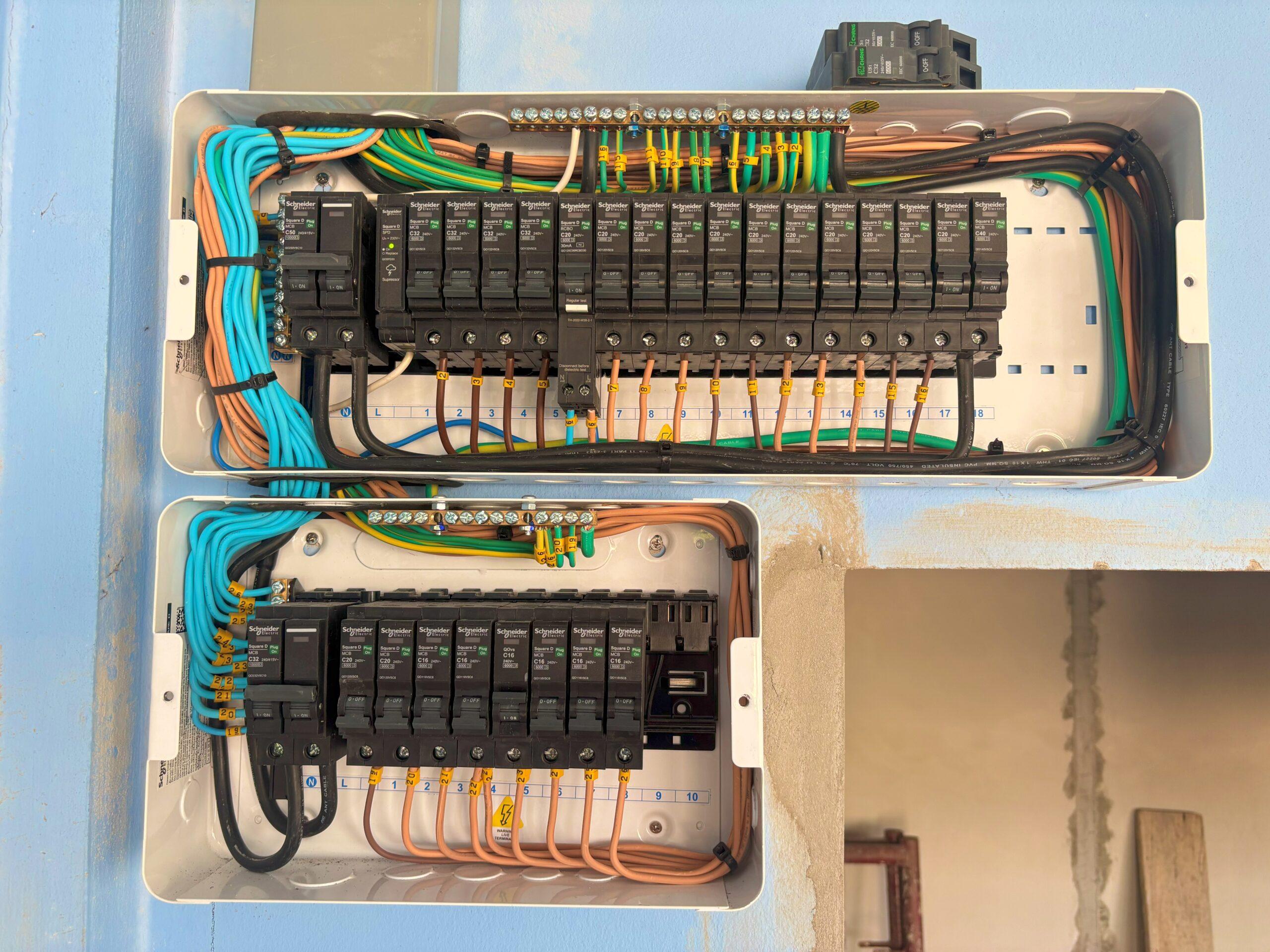 ACES Pattaya electrical installation showing dual stacked distribution sub-panels expanded in a compact space