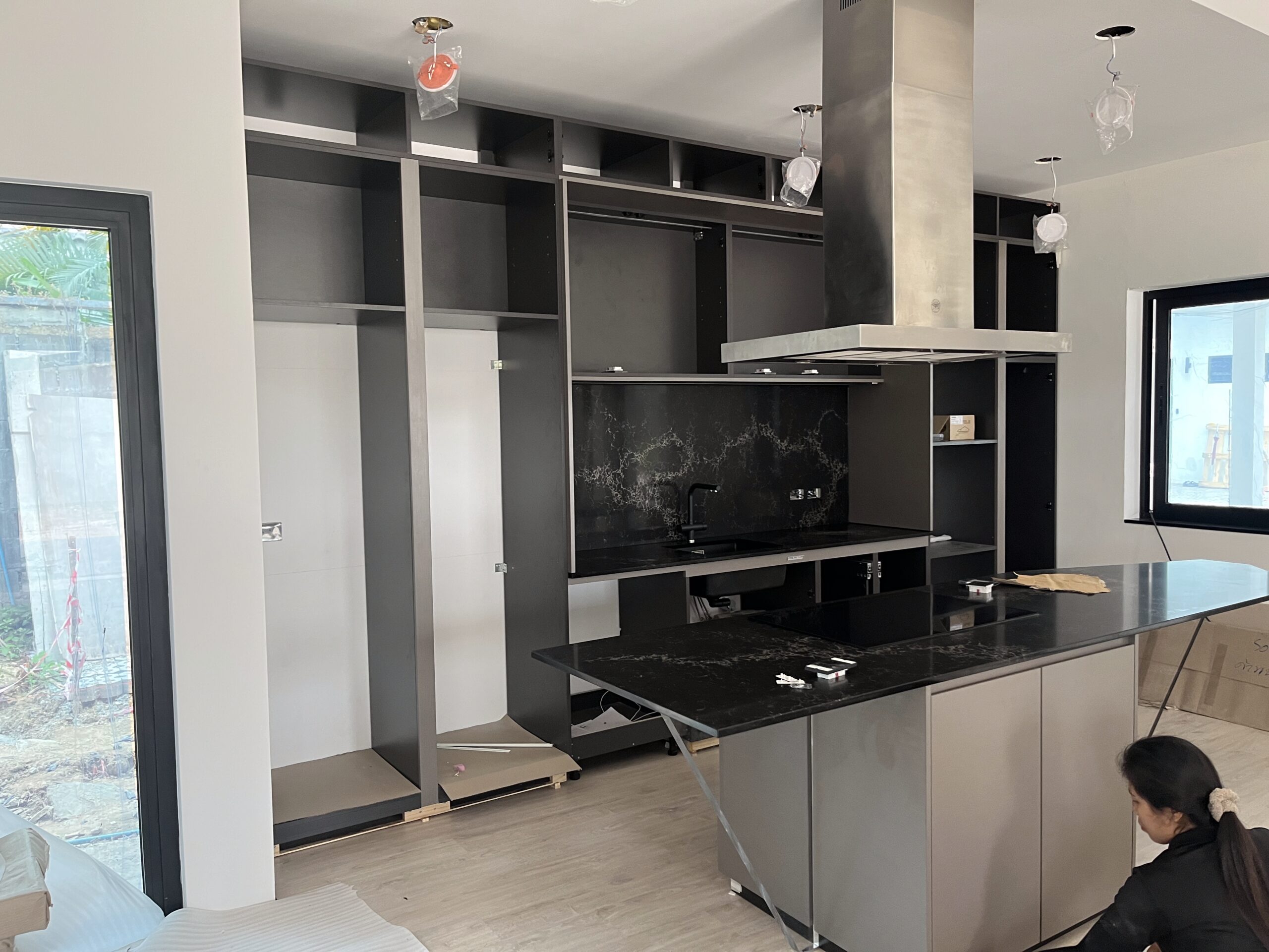Custom modern luxury kitchen cabinetry and center island installation in Pattaya villa by ACES Pattaya
