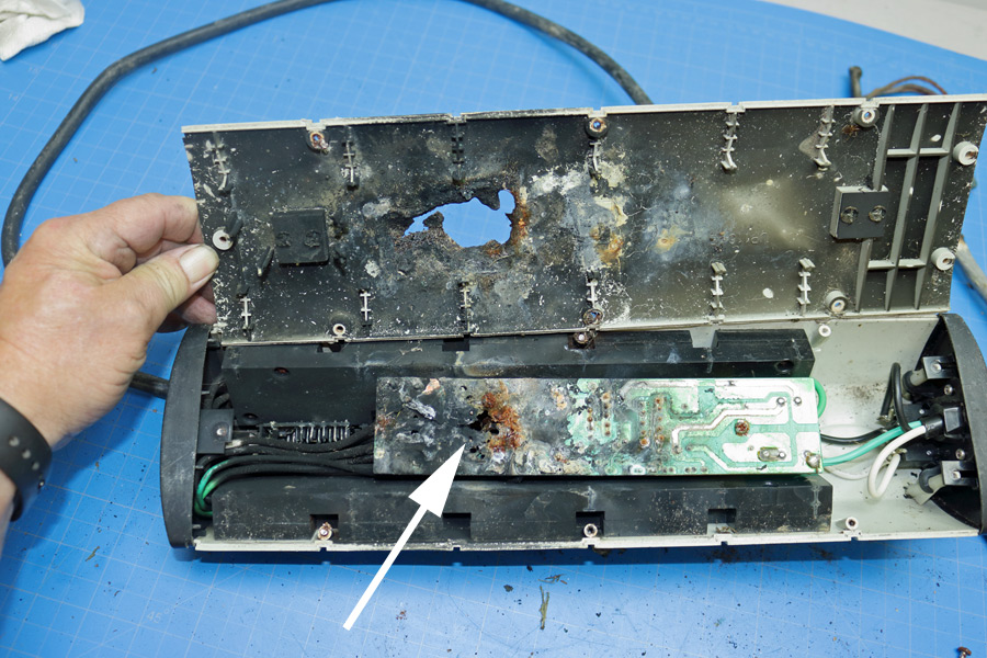 Catastrophic electronic component failure showing a melted plastic casing and a charred circuit board uncovered during an electrical inspection in Pattaya.