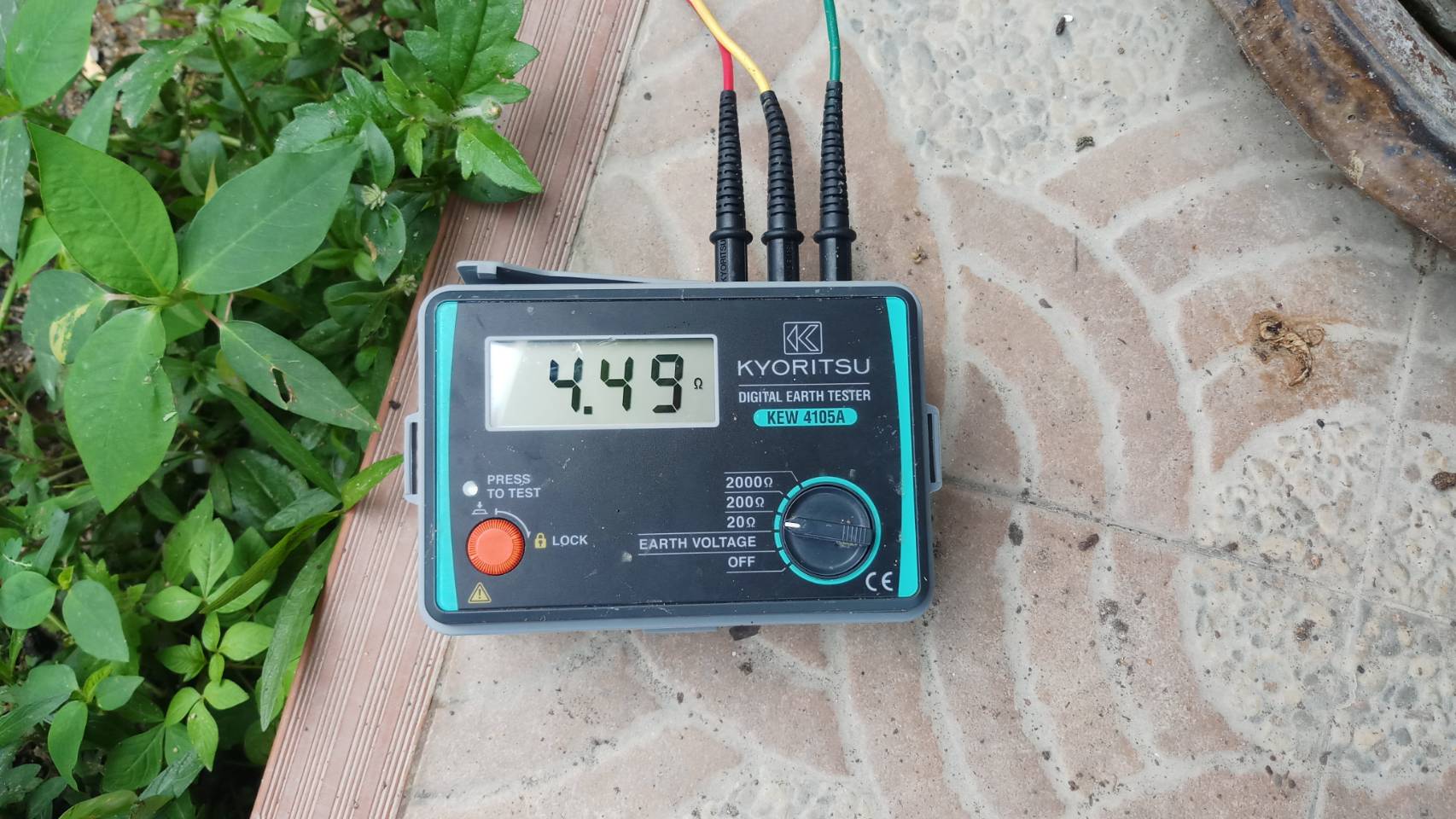 A Kyoritsu KEW 4105A digital earth ground tester showing an excellent low resistance reading of 4.49 Ohms during an electrical safety inspection in Pattaya.