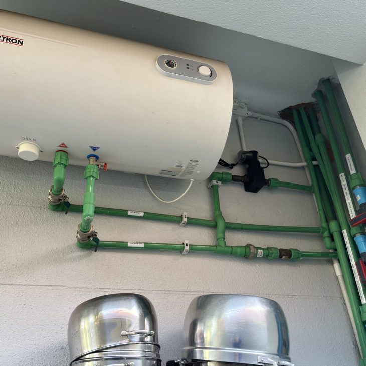 A professionally installed Stiebel Eltron horizontal storage water heater connected to labeled green PPR hot and cold water pipes in Pattaya.