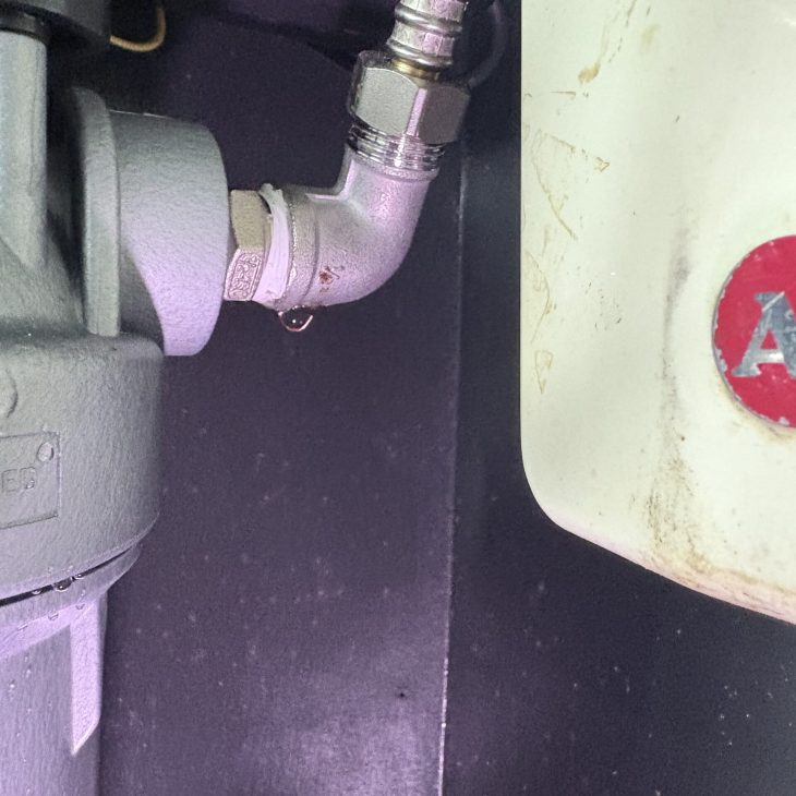 ACES technician diagnosing hairline casting fracture and water leak on filter elbow fitting in Pattaya
